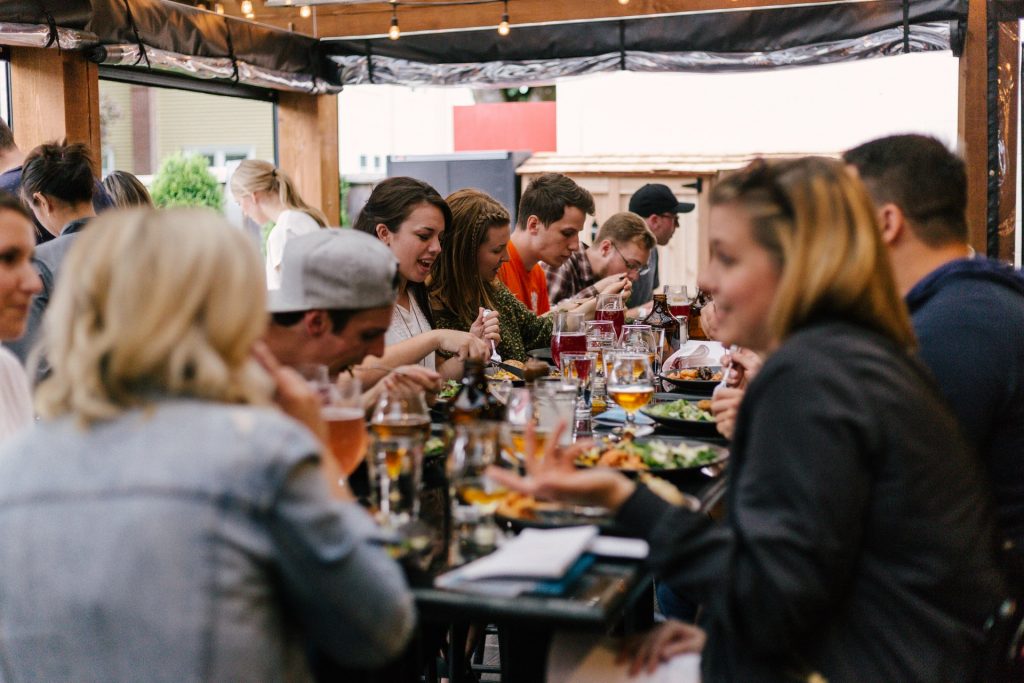 people sitting around a large table eating