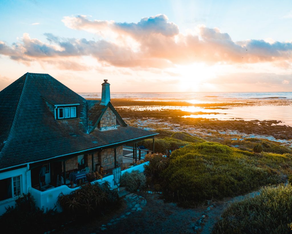 house on the shore at sunset